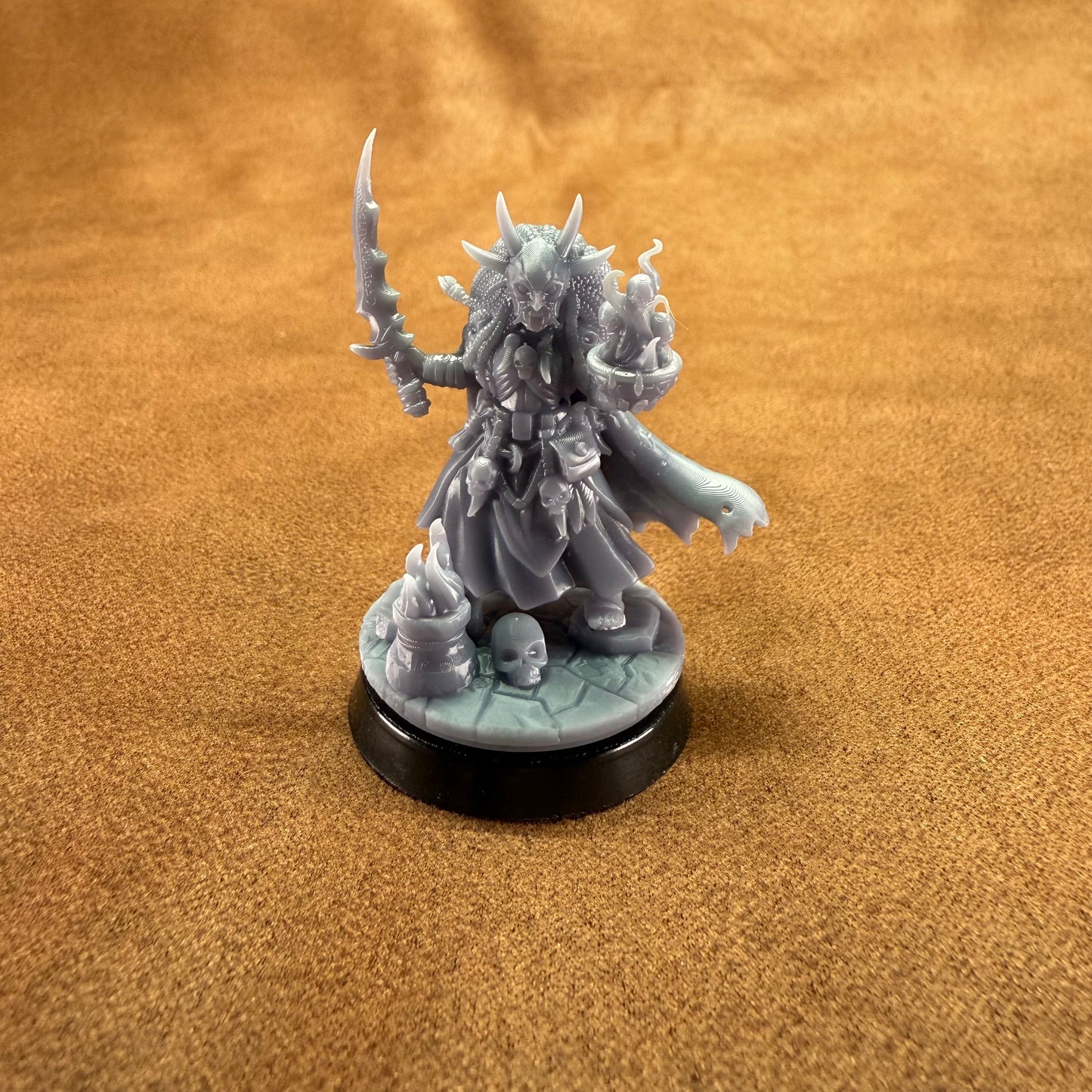 Gray fantasy figurine on a brown surface
