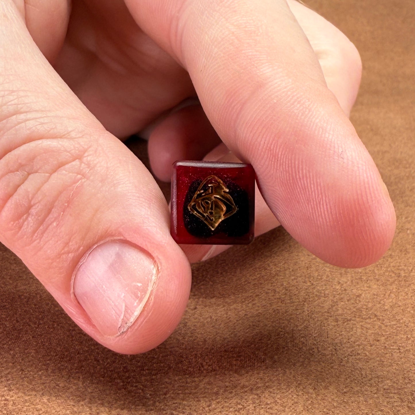 Red and black dice with rogue emblem and gold ink