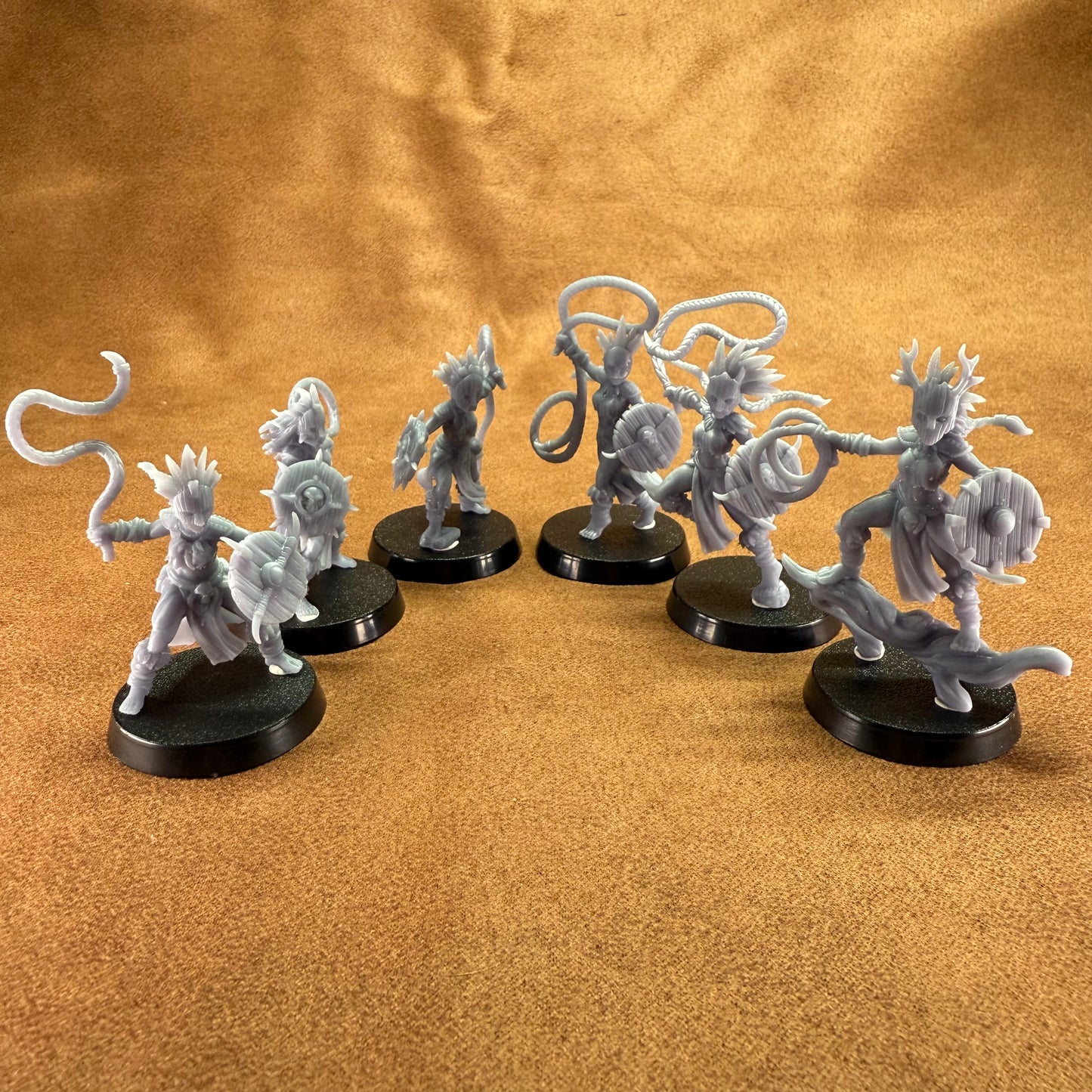 Set of fantasy figurines on a brown surface