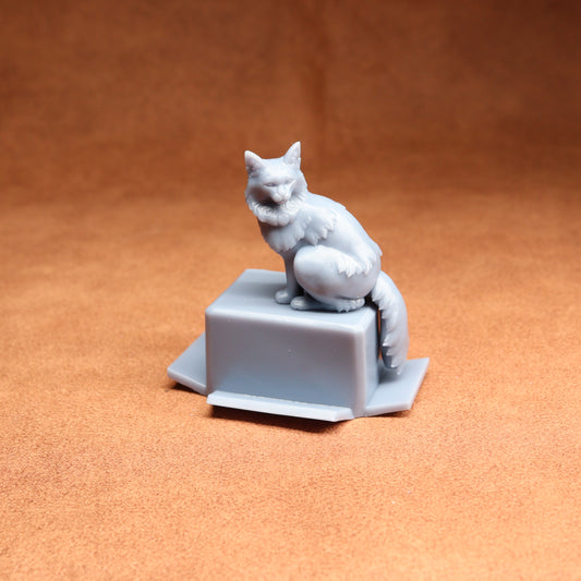 White cat figurine on a square base against an orange background