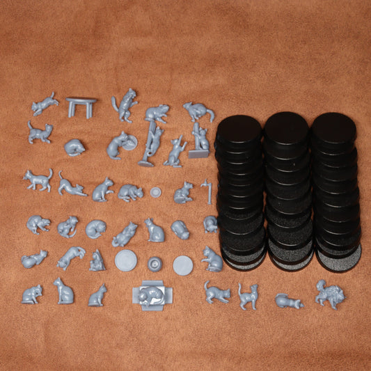 Collection of small animal figurines and black circular objects on a brown surface