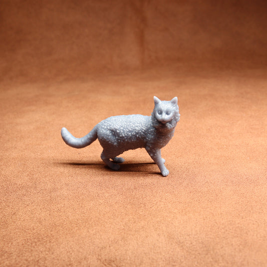 Gray cat figurine on a brown surface