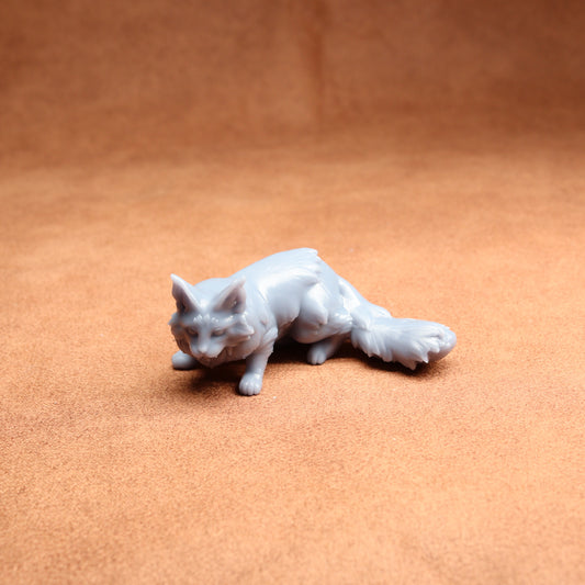 White cat figurine on a brown surface