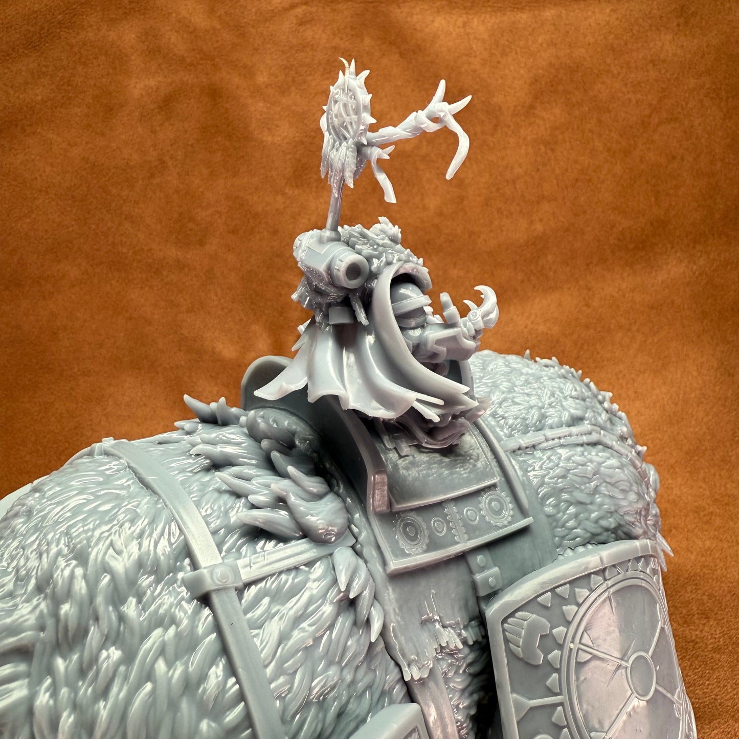 Close-up of a detailed figurine with armor and helmet on a brown background