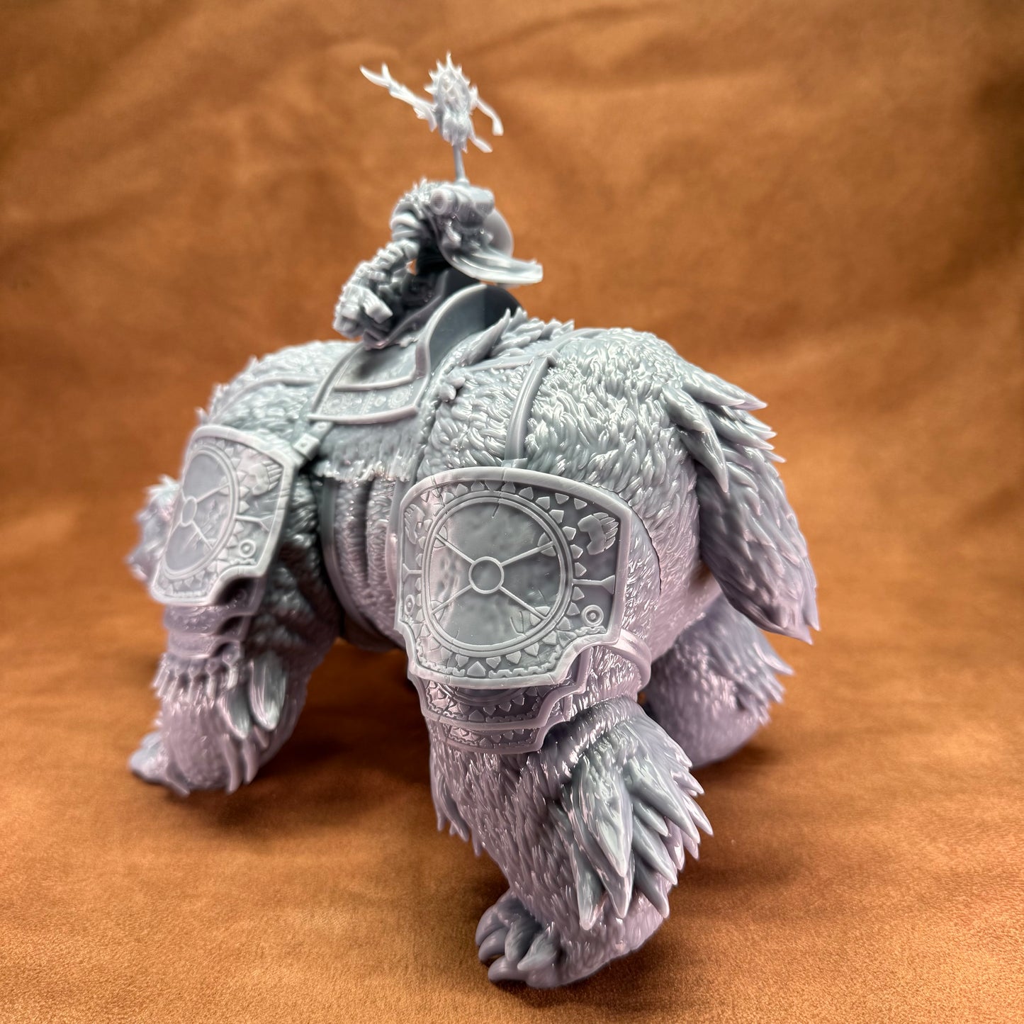 Decorative figurine of an elephant with armor on a brown background