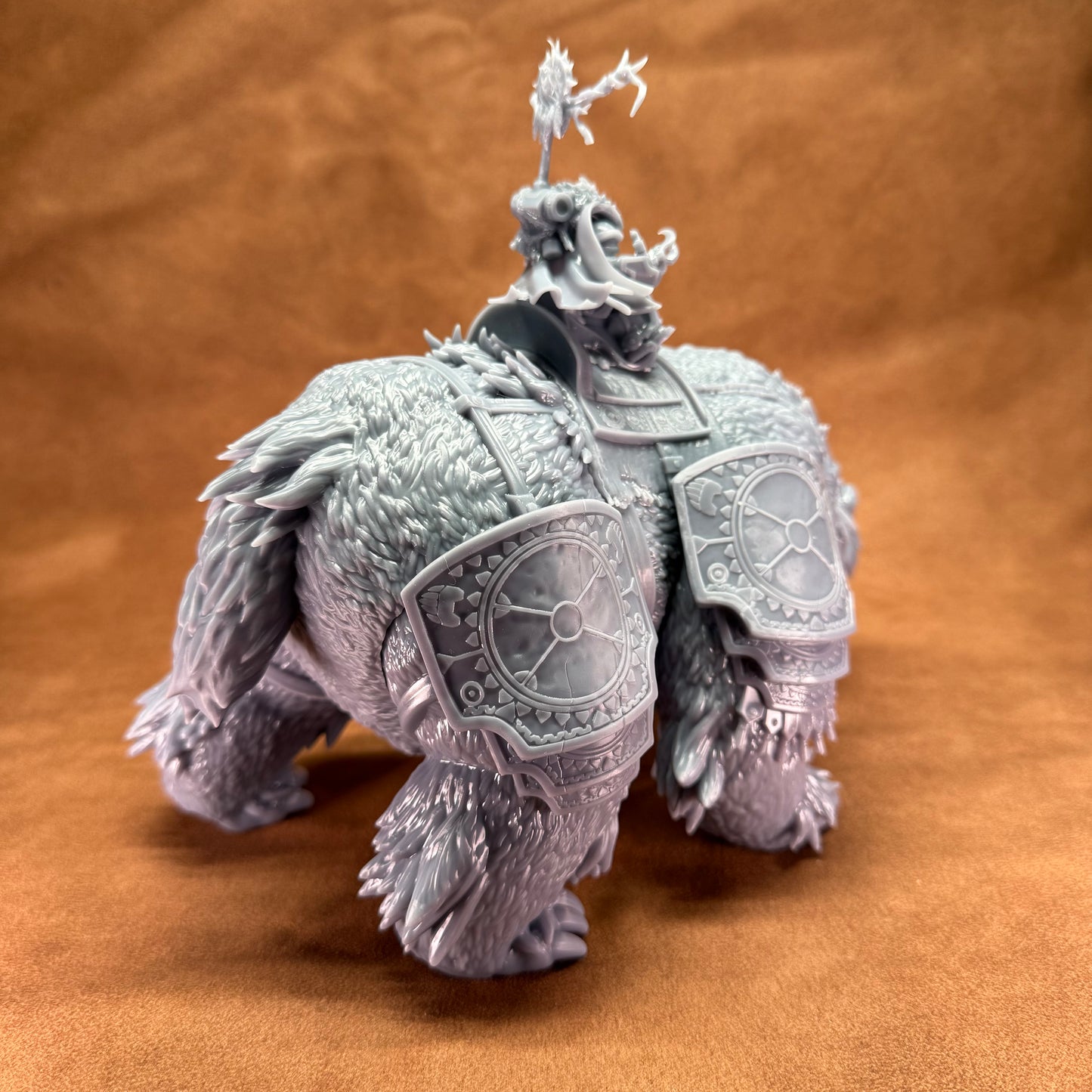 detailed fantasy creature figurine on a brown background