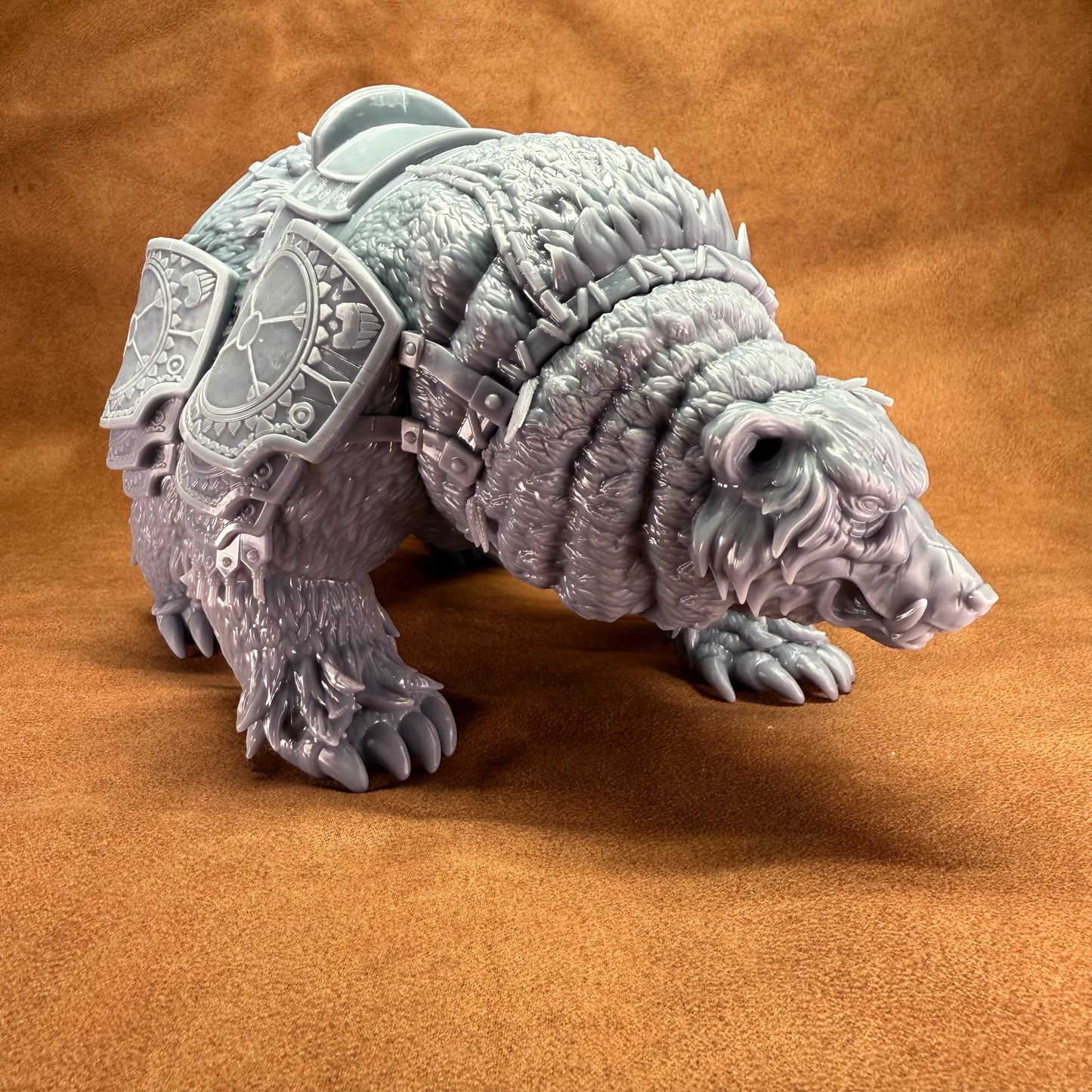 Gray bear-like creature with armor on a brown background