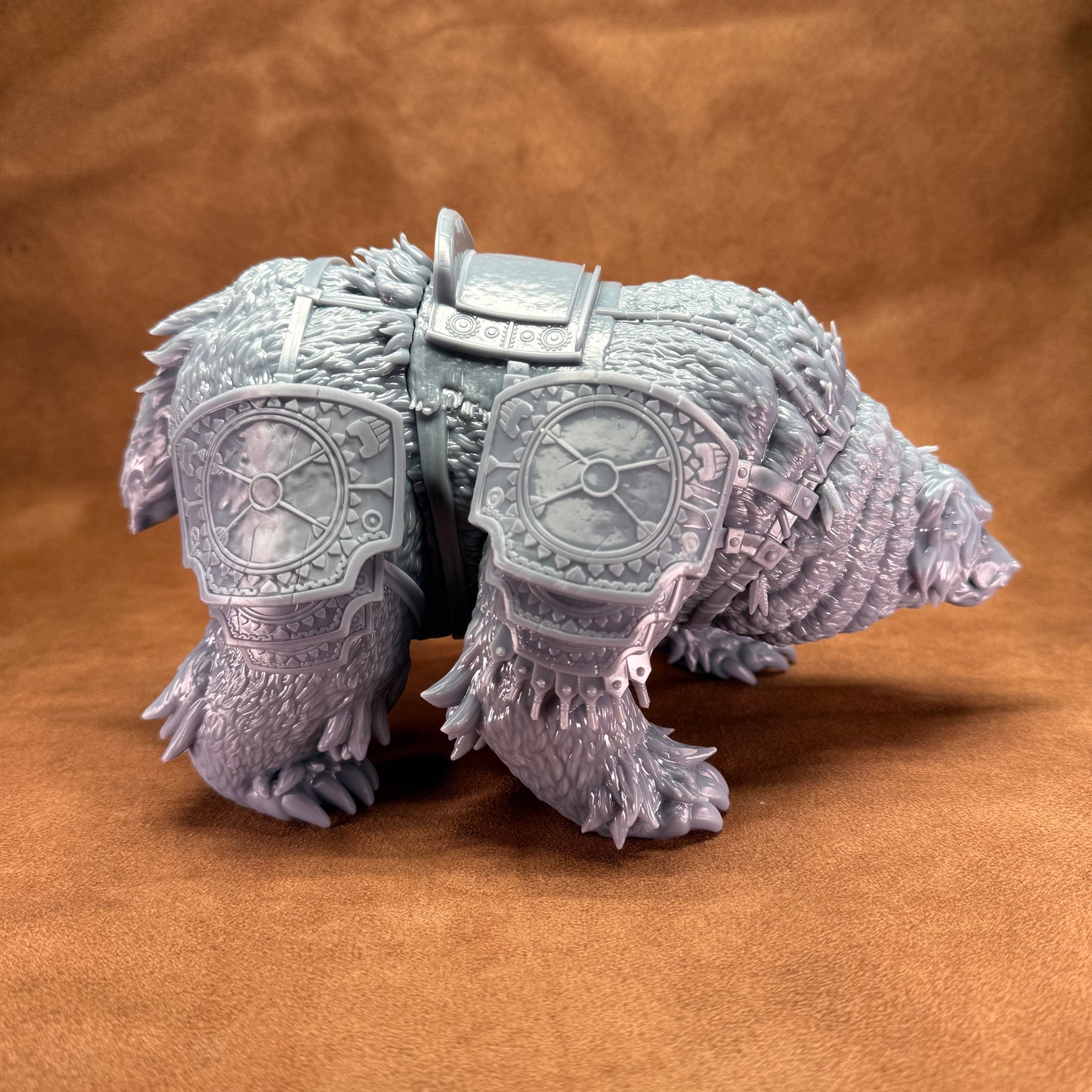 Toy figure of a bear with armor on a brown background