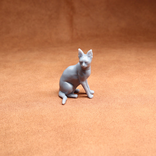 White cat figurine on a brown surface