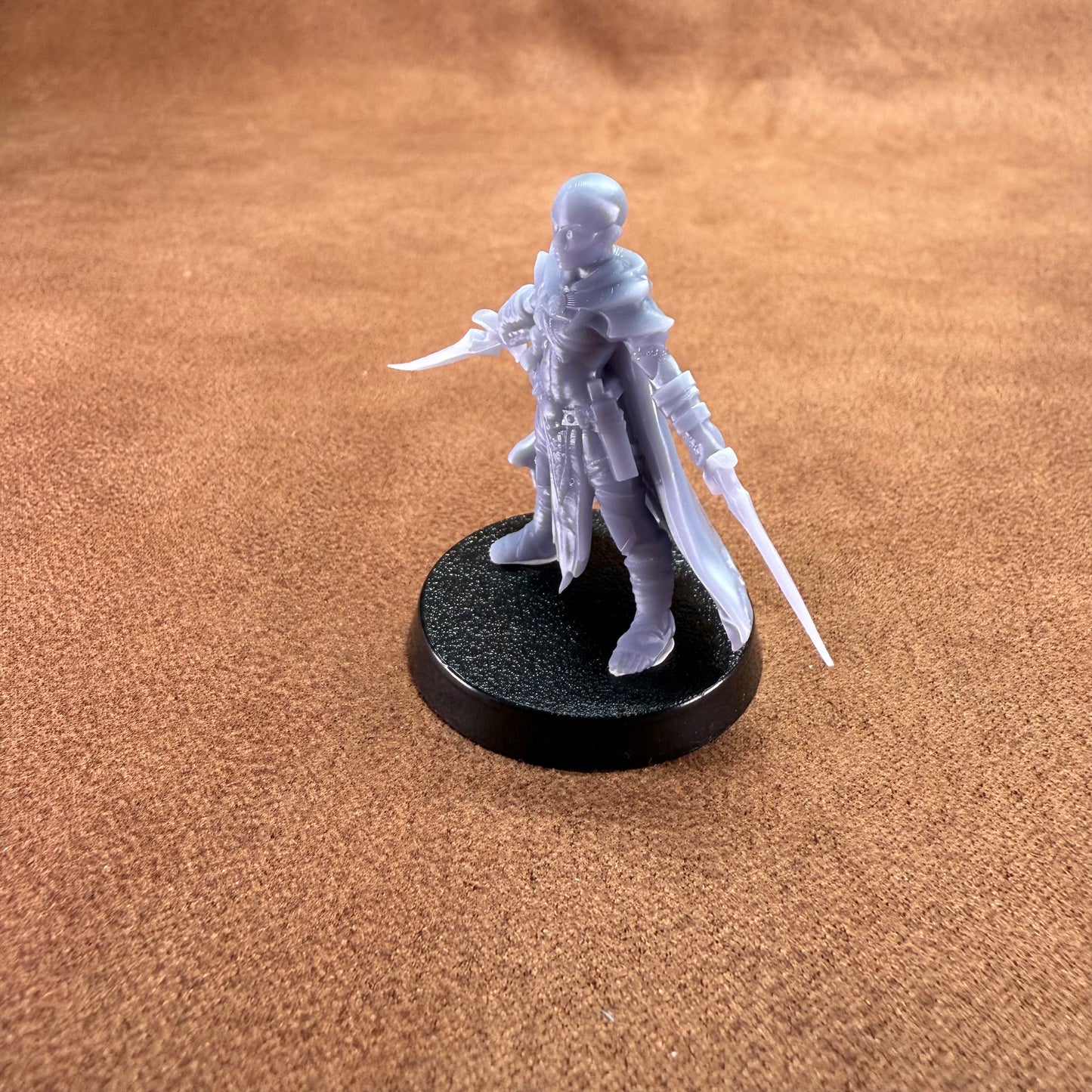 White fantasy figurine on a black base against a brown textured background