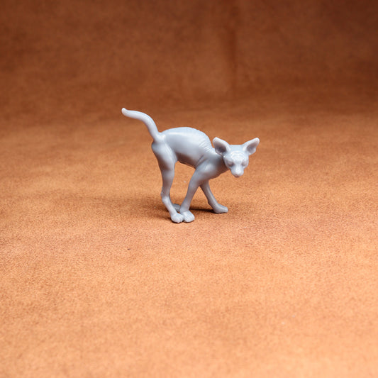 White cat figurine on a brown surface