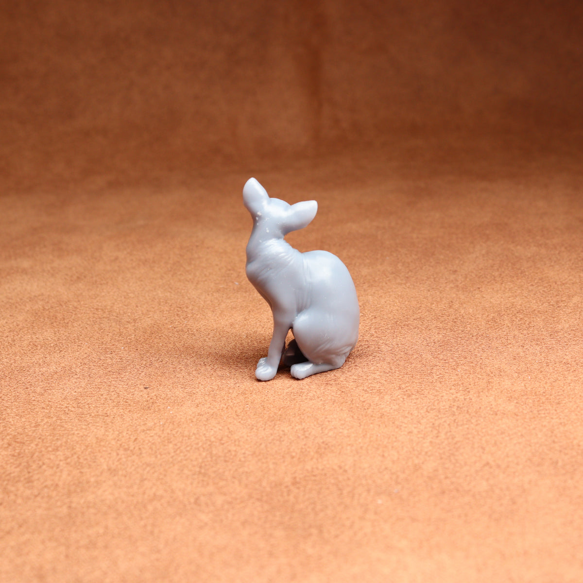 White ceramic deer figurine on a brown surface