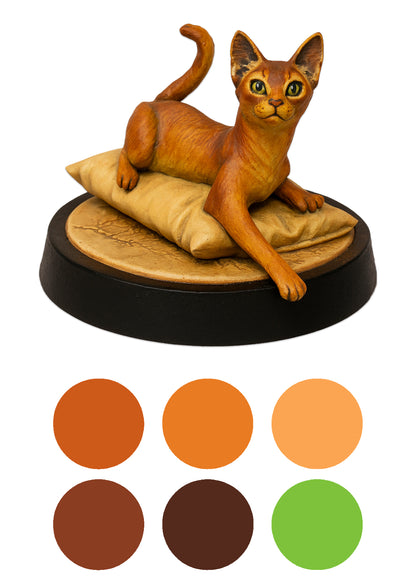 Cat figurine on a cushion with color swatches below