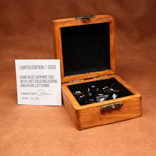 Wooden box with dark blue sapphire dice and a card on a brown background