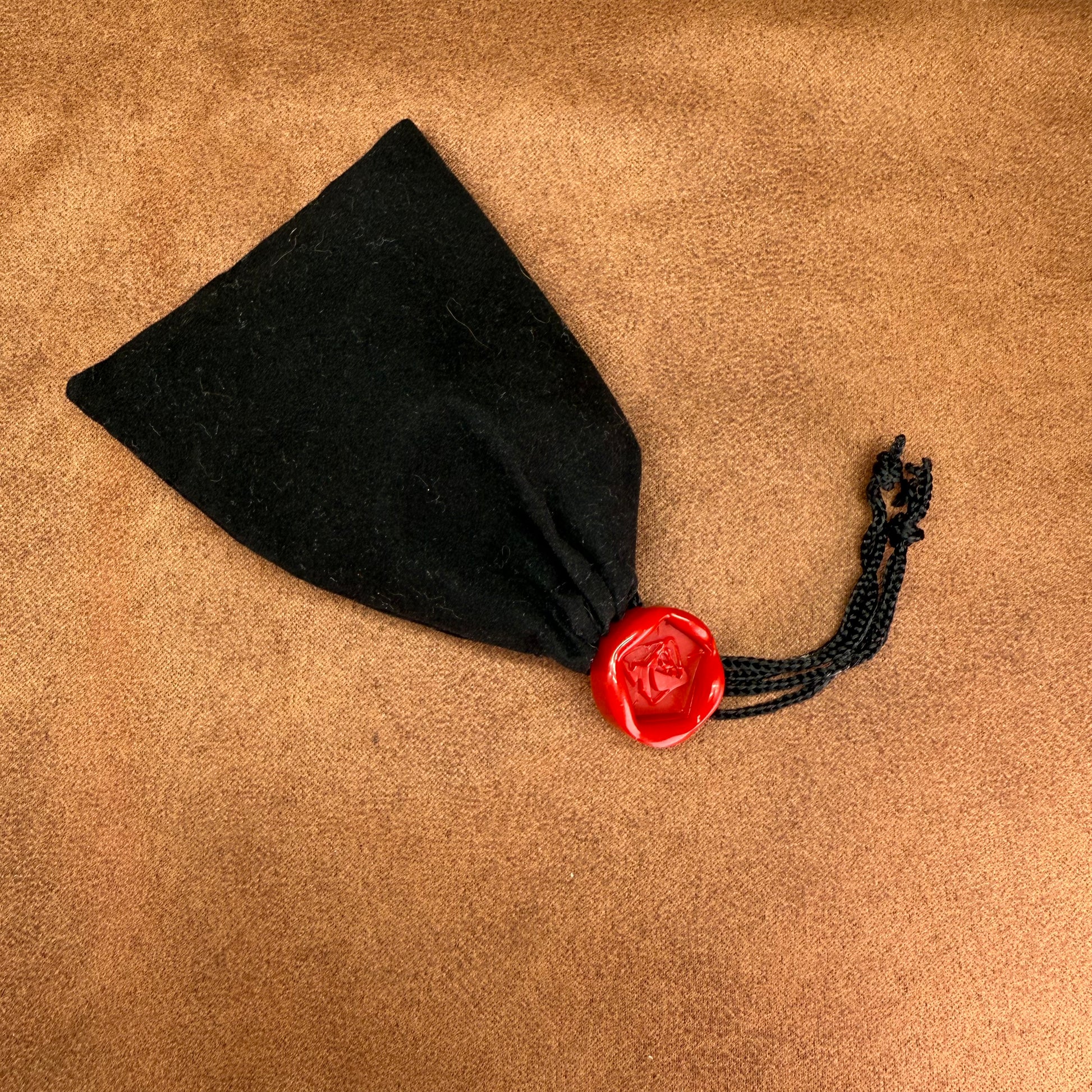 Red and black dice with rogue emblem and gold ink