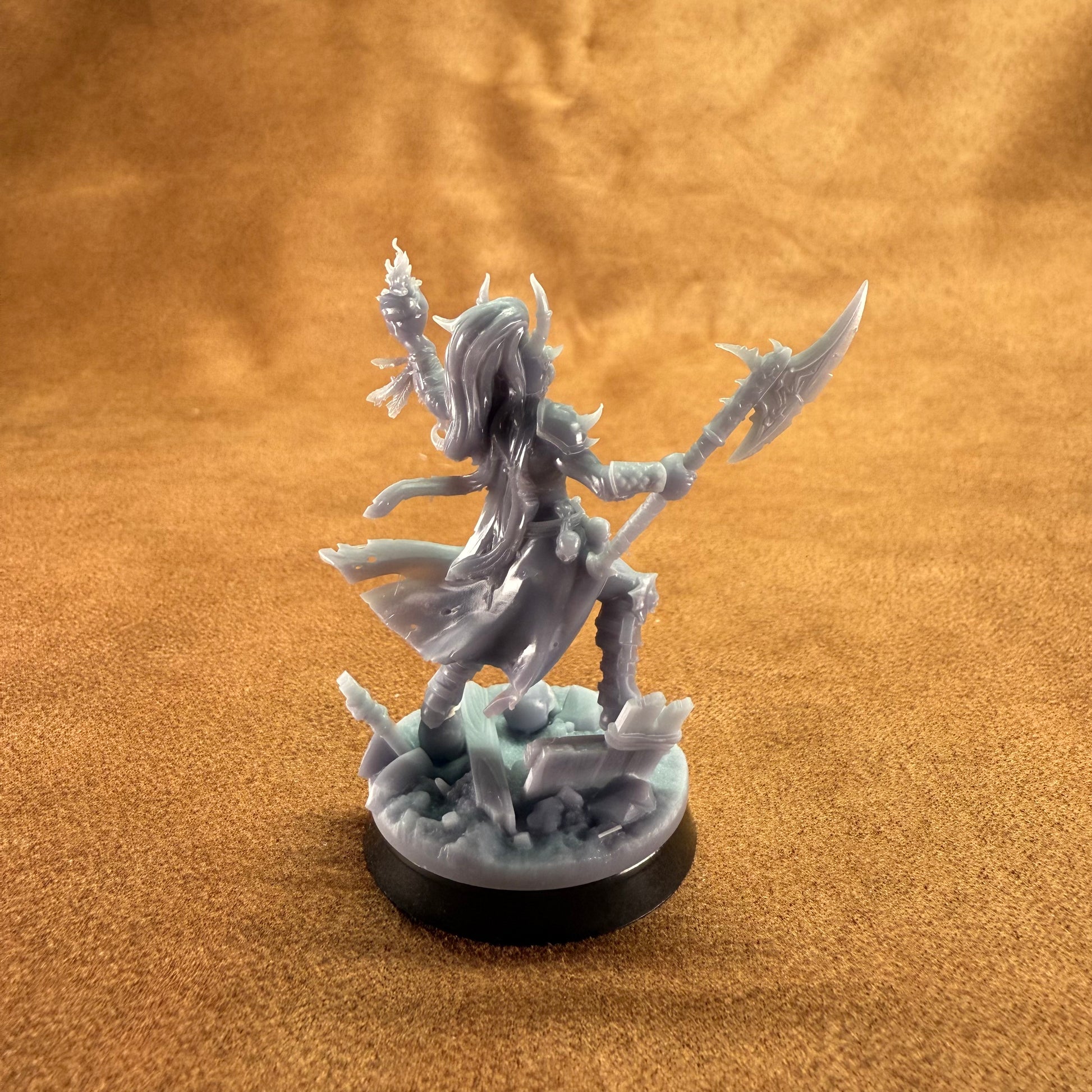 Fantasy figurine on a round base against a brown background