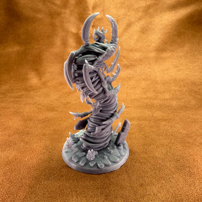Fantasy creature figurine on a textured brown surface