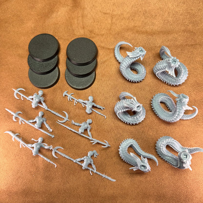 Collection of gray plastic figurines and dragon models on a brown surface