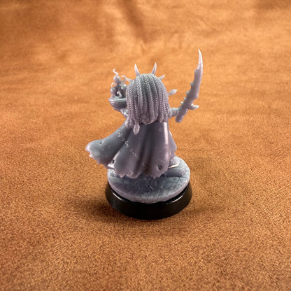 Gray fantasy figurine on a brown surface