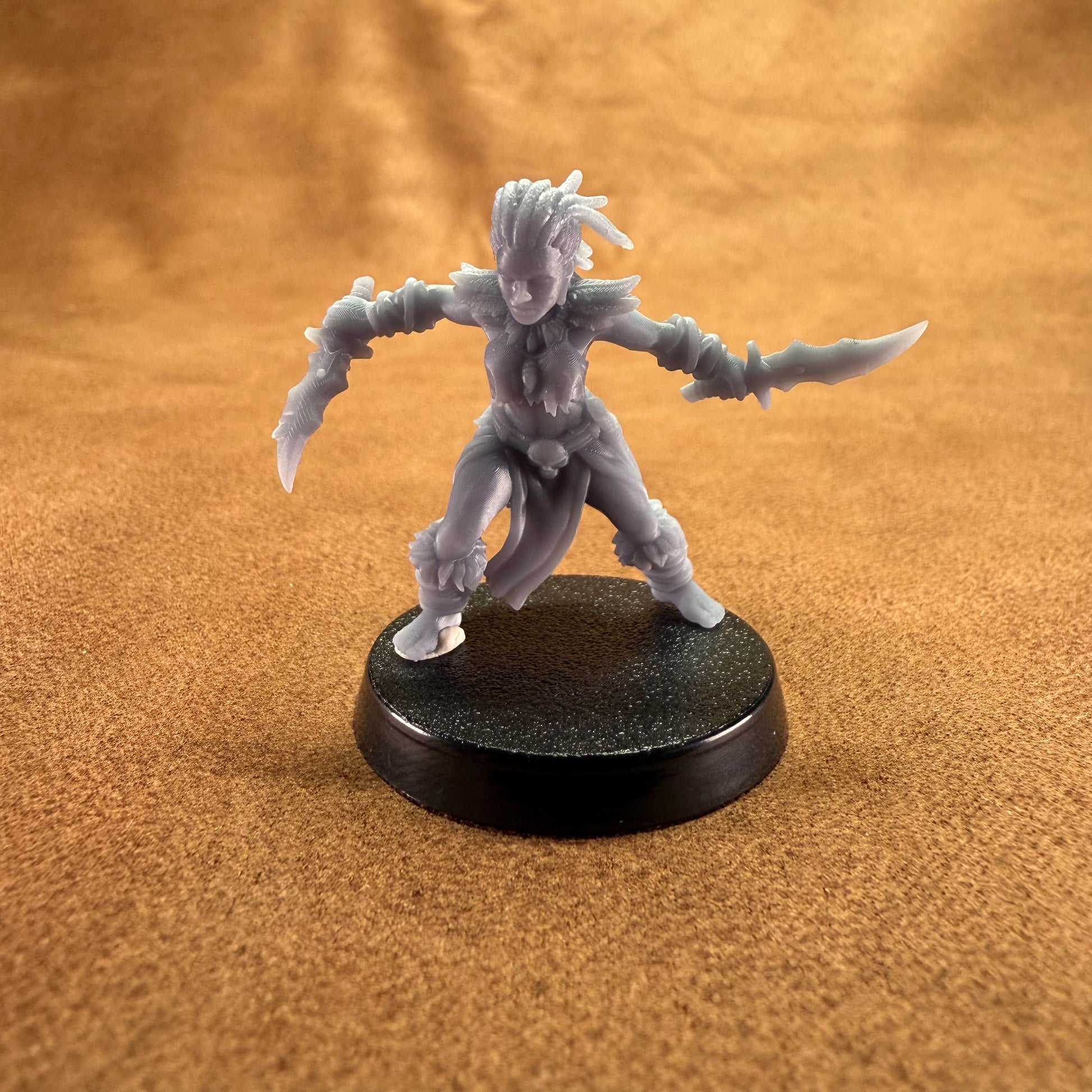 Gray fantasy figurine on a black base against a brown background