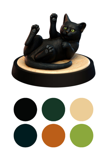 Black cat figurine on a wooden base with color swatches below