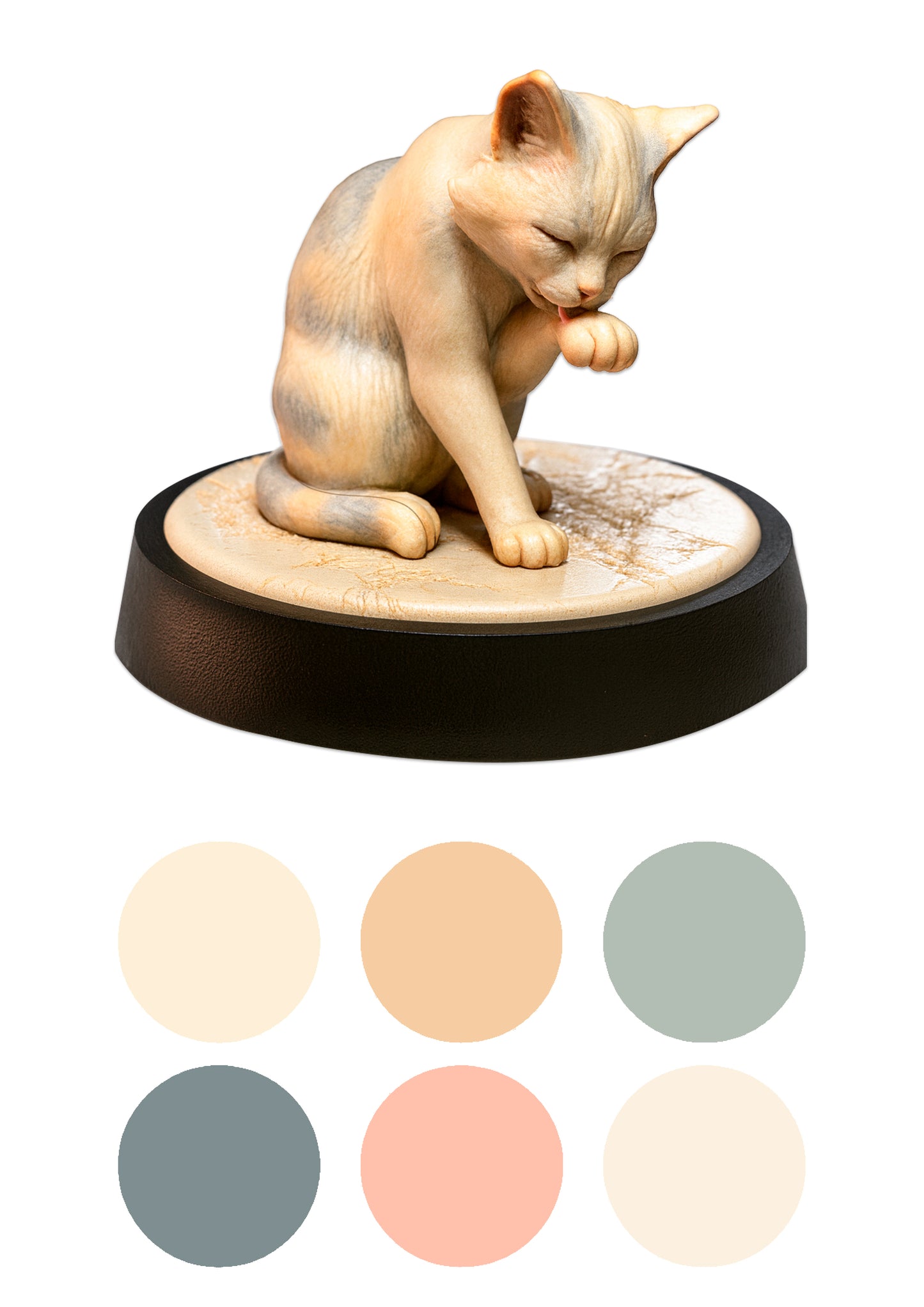 a cat licking its paw on a black base with colour swatches beneath it on a white background.
