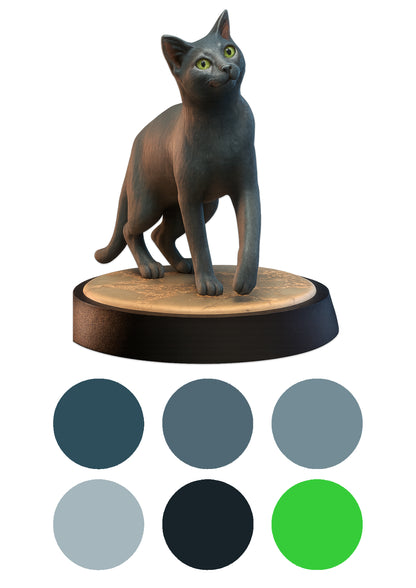 Cat figurine on a wooden base with color swatches below