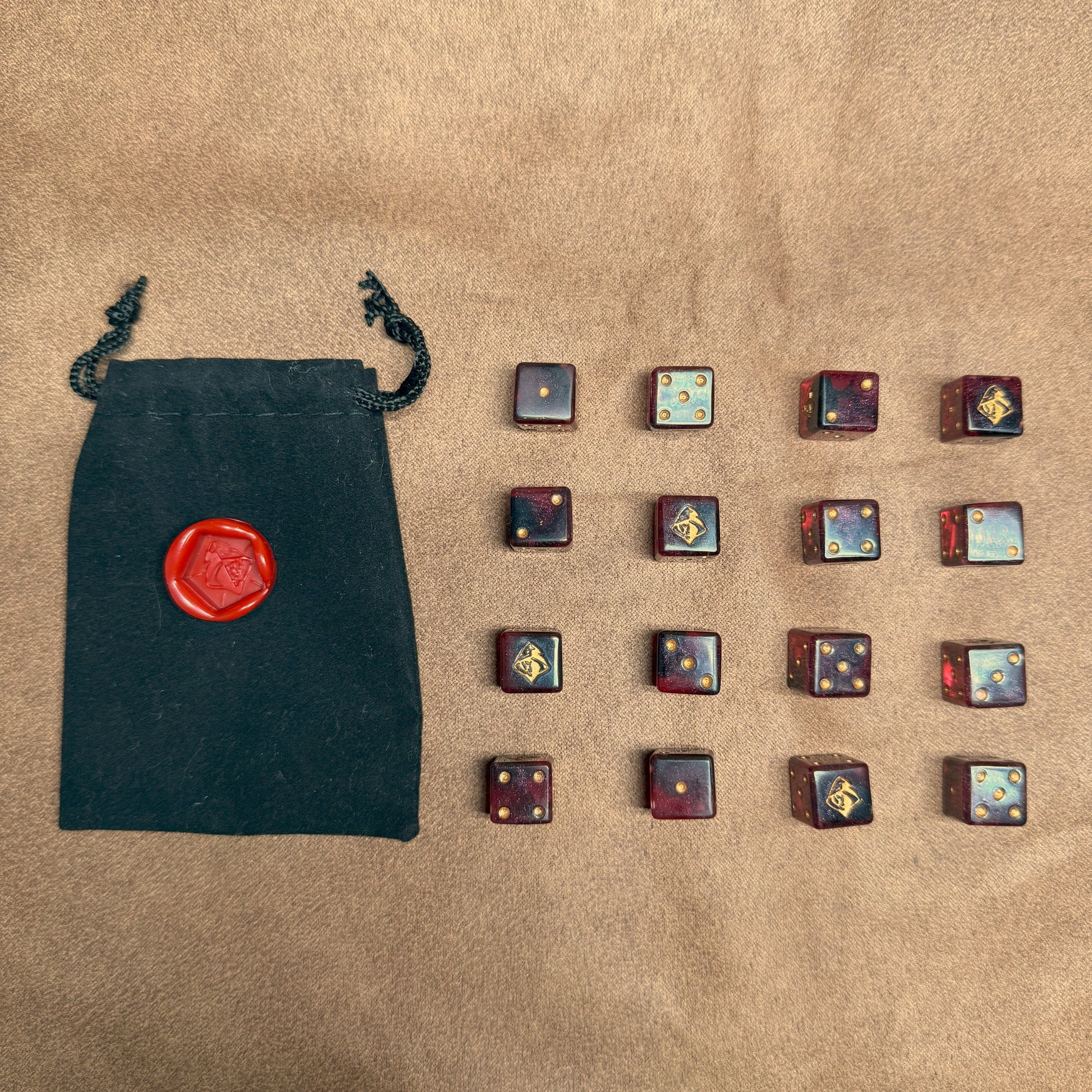 Red and black dice with rogue emblem and gold ink