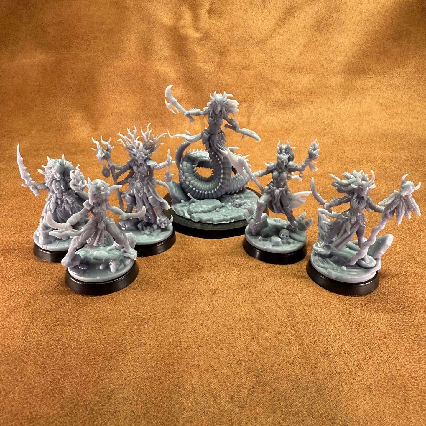 Set of fantasy figurines on a brown surface
