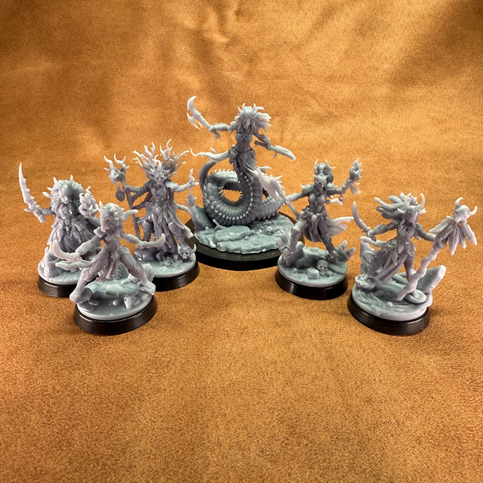 Set of fantasy figurines on a brown surface