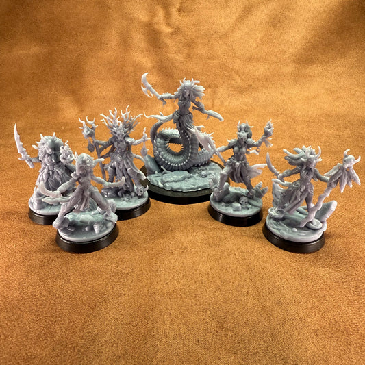 Set of fantasy figurines on a brown surface