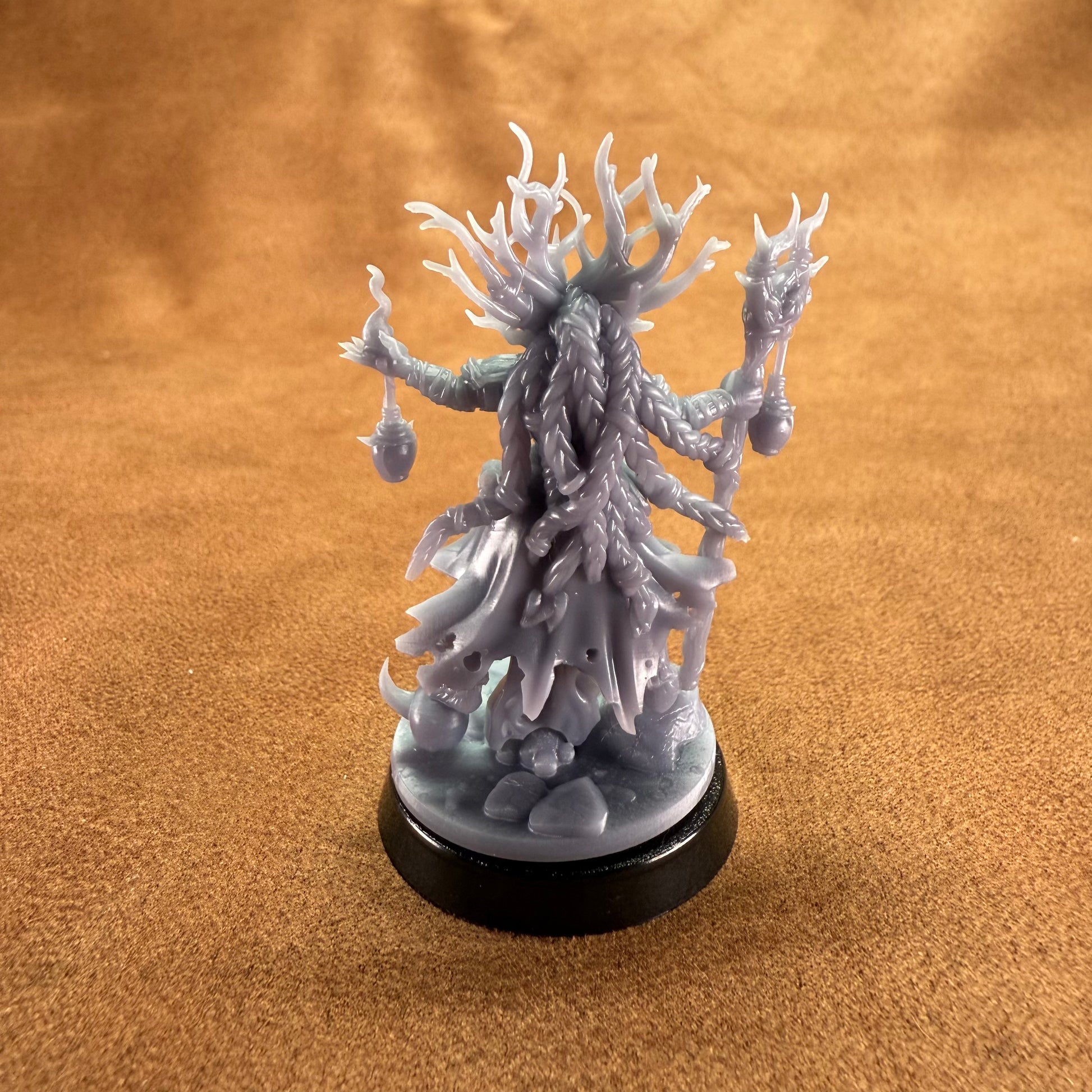 White fantasy creature figurine on a brown surface