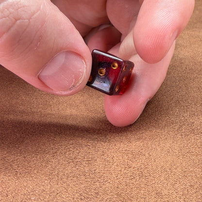 Red and black dice with rogue emblem and gold ink