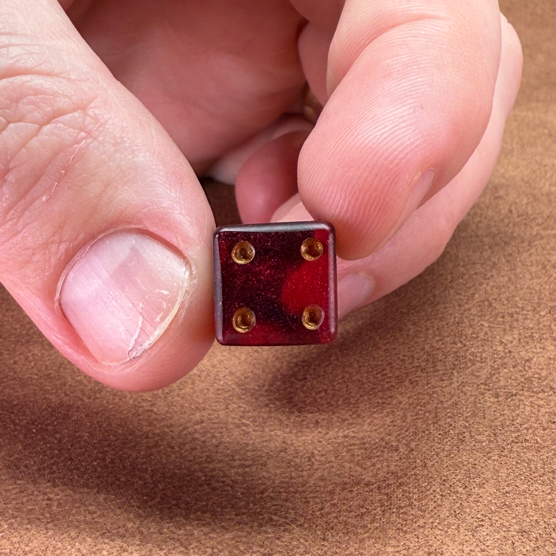 Red and black dice with rogue emblem and gold ink