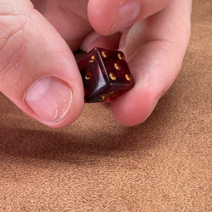 Red and black dice with rogue emblem and gold ink