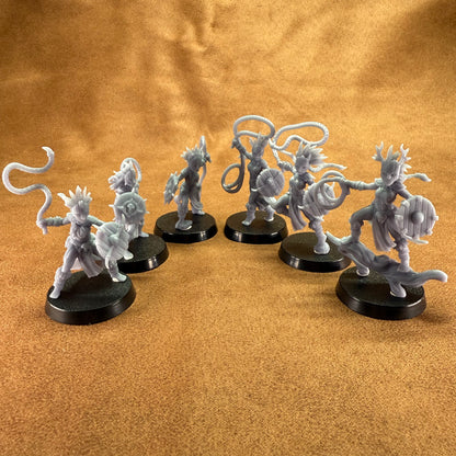 Set of fantasy figurines on a brown surface