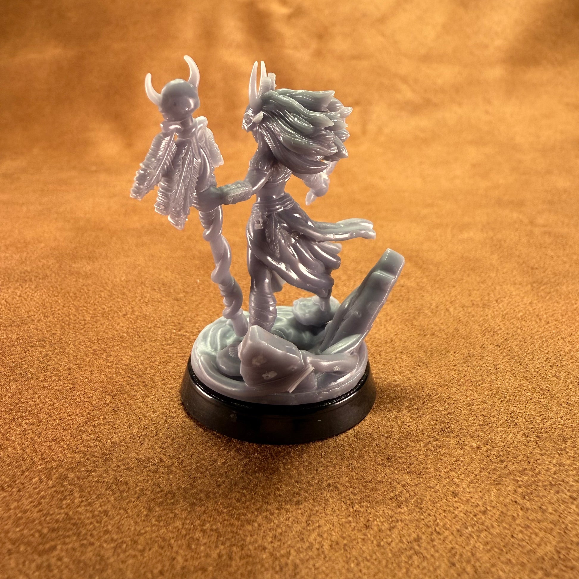 Miniature figurine on a brown surface