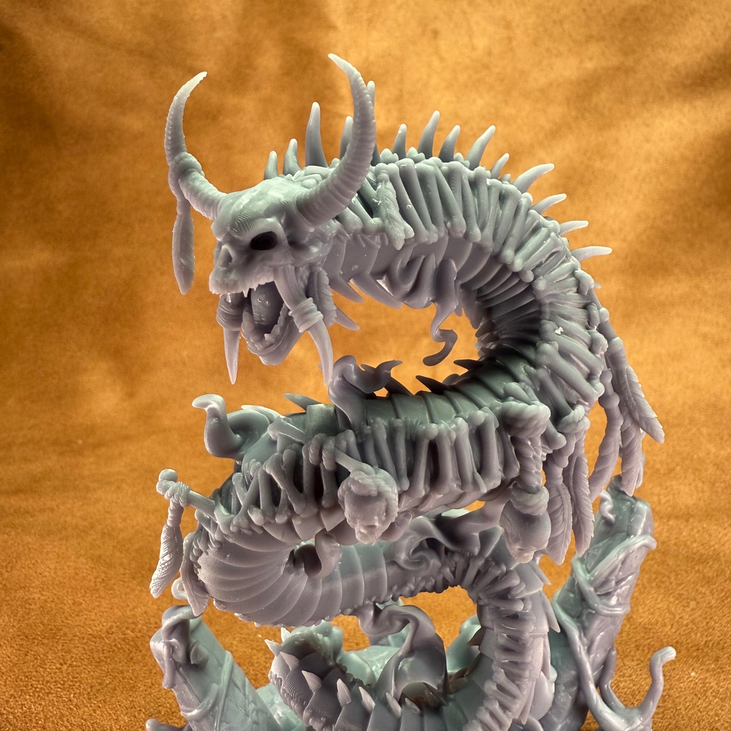 Dragon-like creature figurine on an orange background