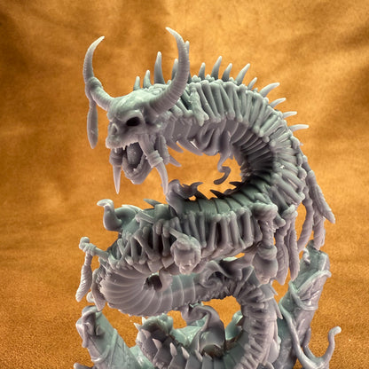 Dragon-like creature figurine on an orange background