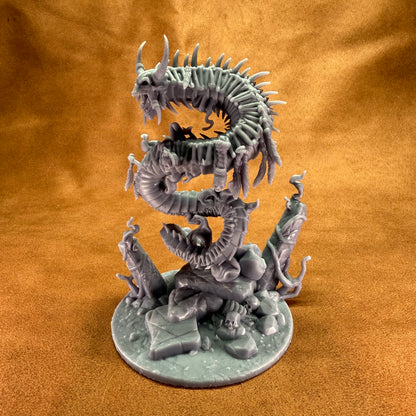 Dragon-like creature figurine on a round base against a brown background