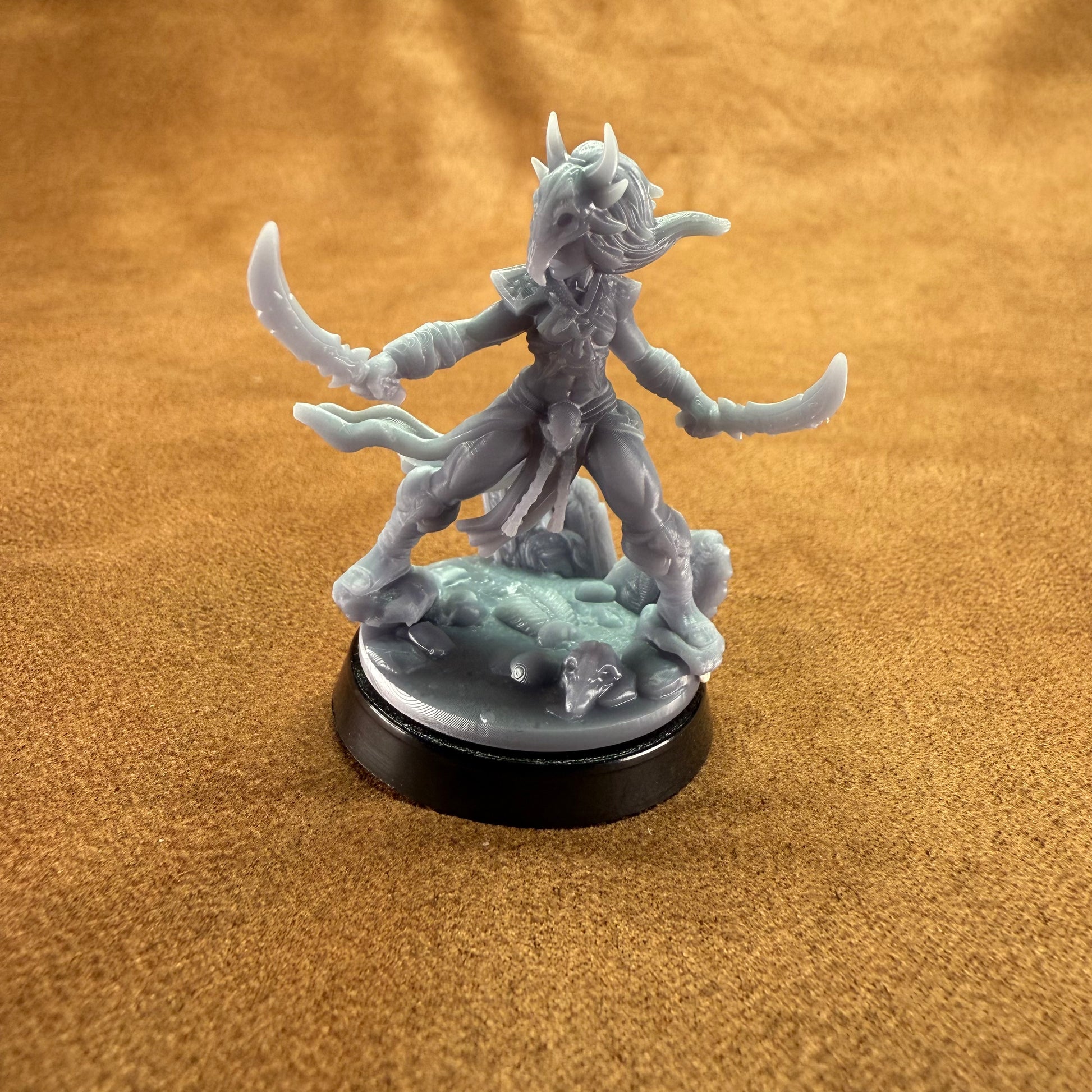 yrah an amazonian warrior hero miniature on a brown background.