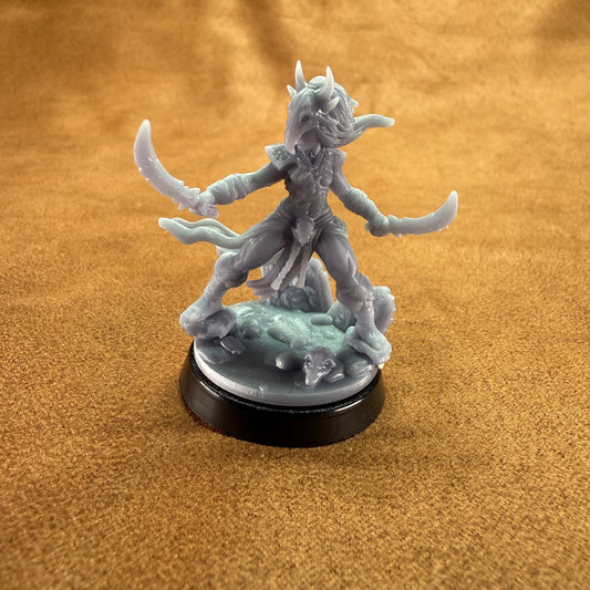 yrah an amazonian warrior hero miniature on a brown background.