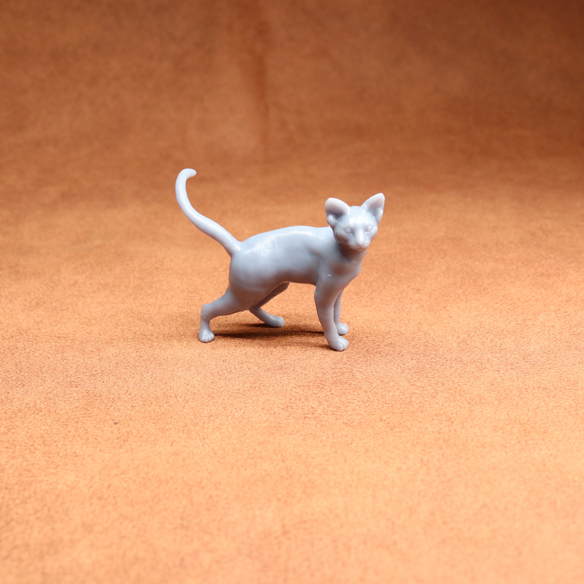 White cat figurine on a brown surface