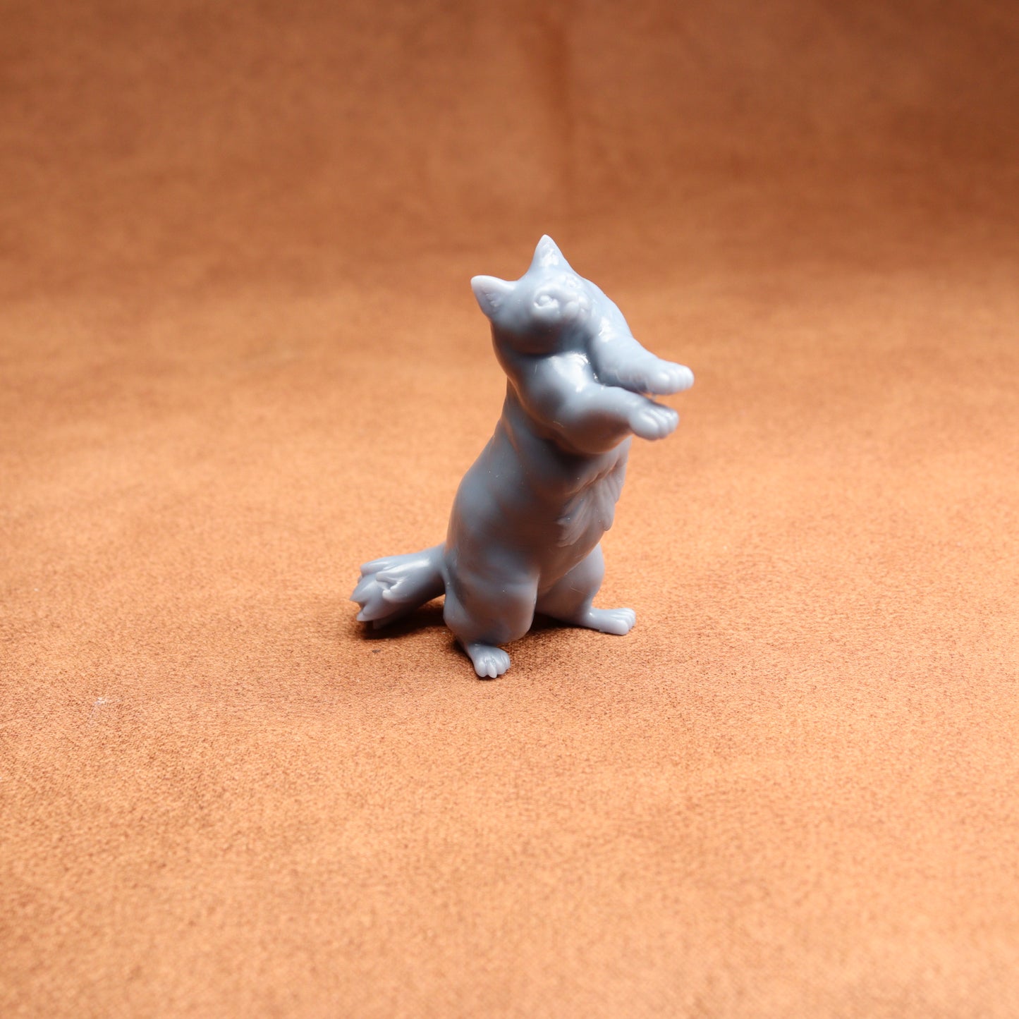 Gray dog figurine on a brown surface