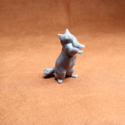 Gray dog figurine on a brown surface
