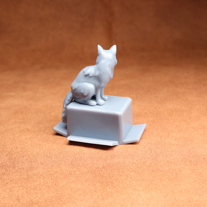 White ceramic cat figurine on a square base against an orange background