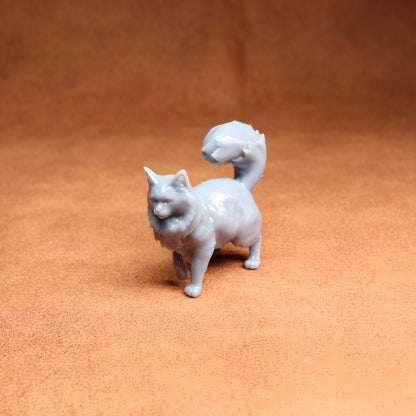 White ceramic cat figurine on a brown surface