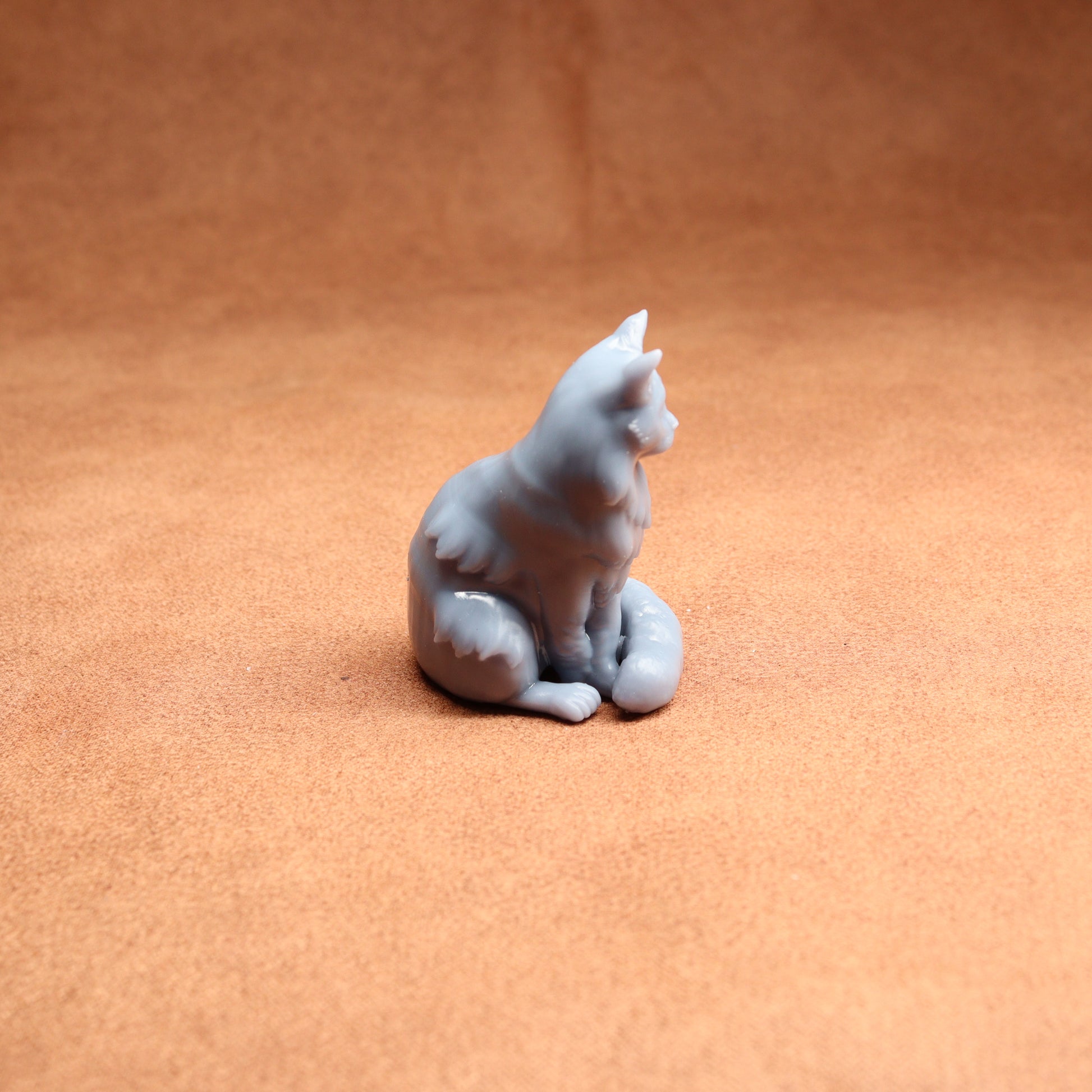 White ceramic cat figurine on a brown surface