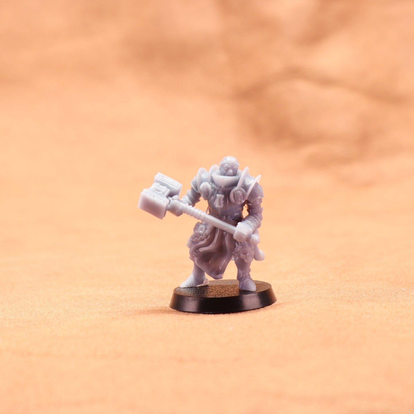 Miniature figurine of a warrior holding a axe on an orange background