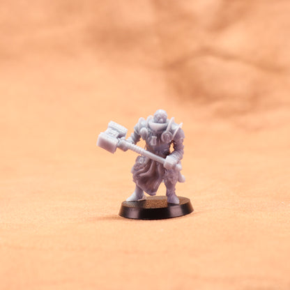 Miniature figurine of a warrior holding a axe on an orange background